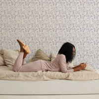 White girls teen room interior with lavender color tiny butterflies wallpaper