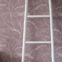 Vintage shabby chic style girl's room interior with dusty pink floral wallpaper
