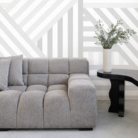 light grey interior design with textured sofa and geometric shaped wall mural