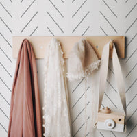 toddler girls bedroom interior with simple grey herringbone inspired wallpaper design