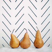 Navy blue herringbone design removable wallpaper in coastal kitchen interior with marble countertop