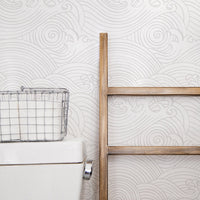Coastal farmhouse style bathroom with wave design wallpaper
